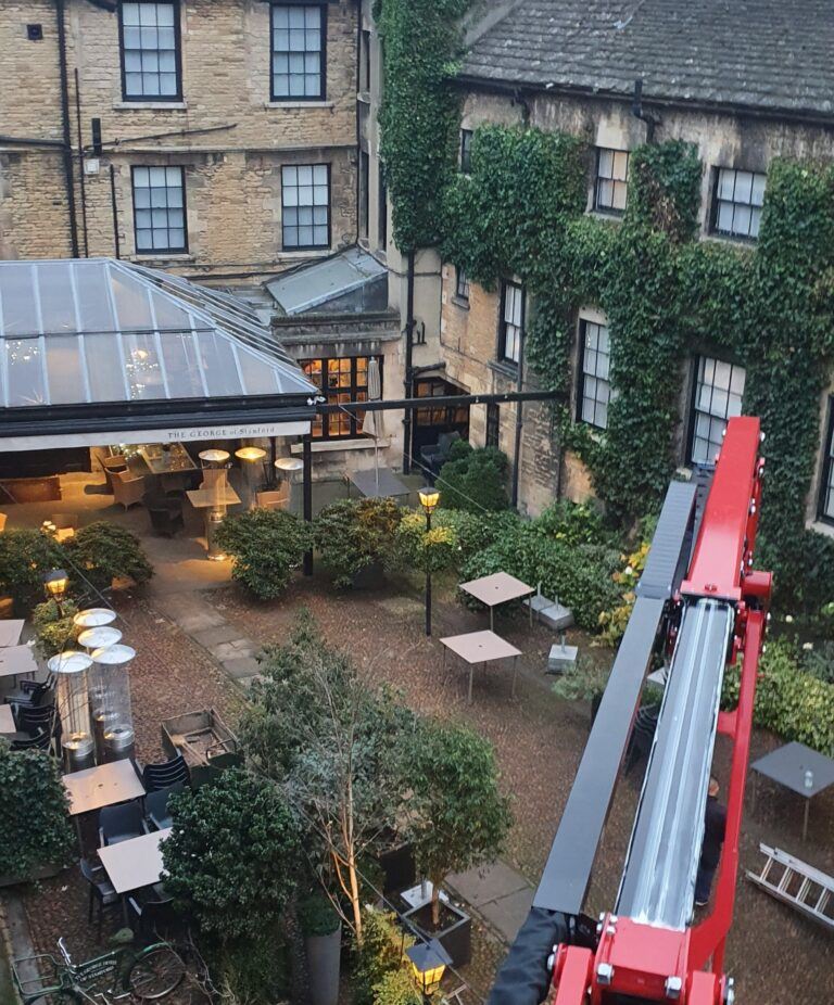 17m Hinowa 17.75m spiderlift trimming ivy in the courtyard of The George of Stamford - Access platfrom hire from Warren Access