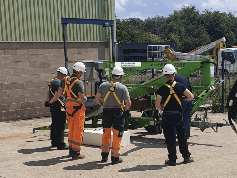 IPAF Training with trainees wearing safety harnesses - always wear a harness when operating a boom lift.